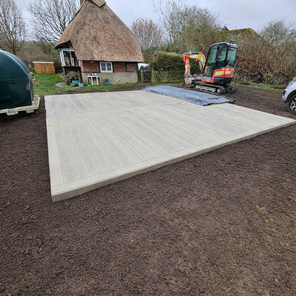 Finished reinforced concrete slab for an outbuilding at a thatched listed property in Basingstoke