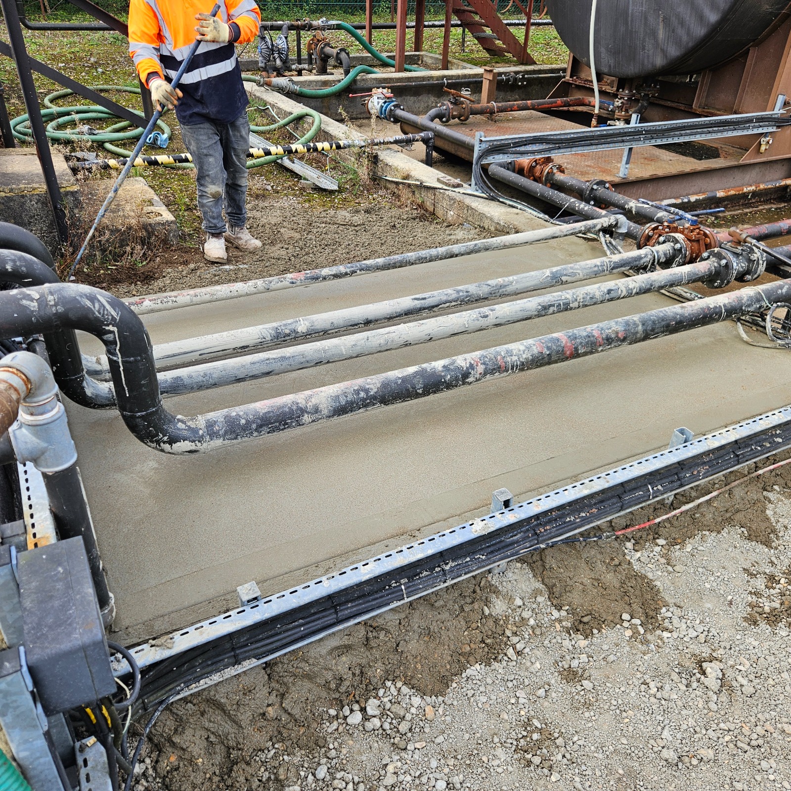 Concrete bund being poured beneath live oil pipelines in Horndean