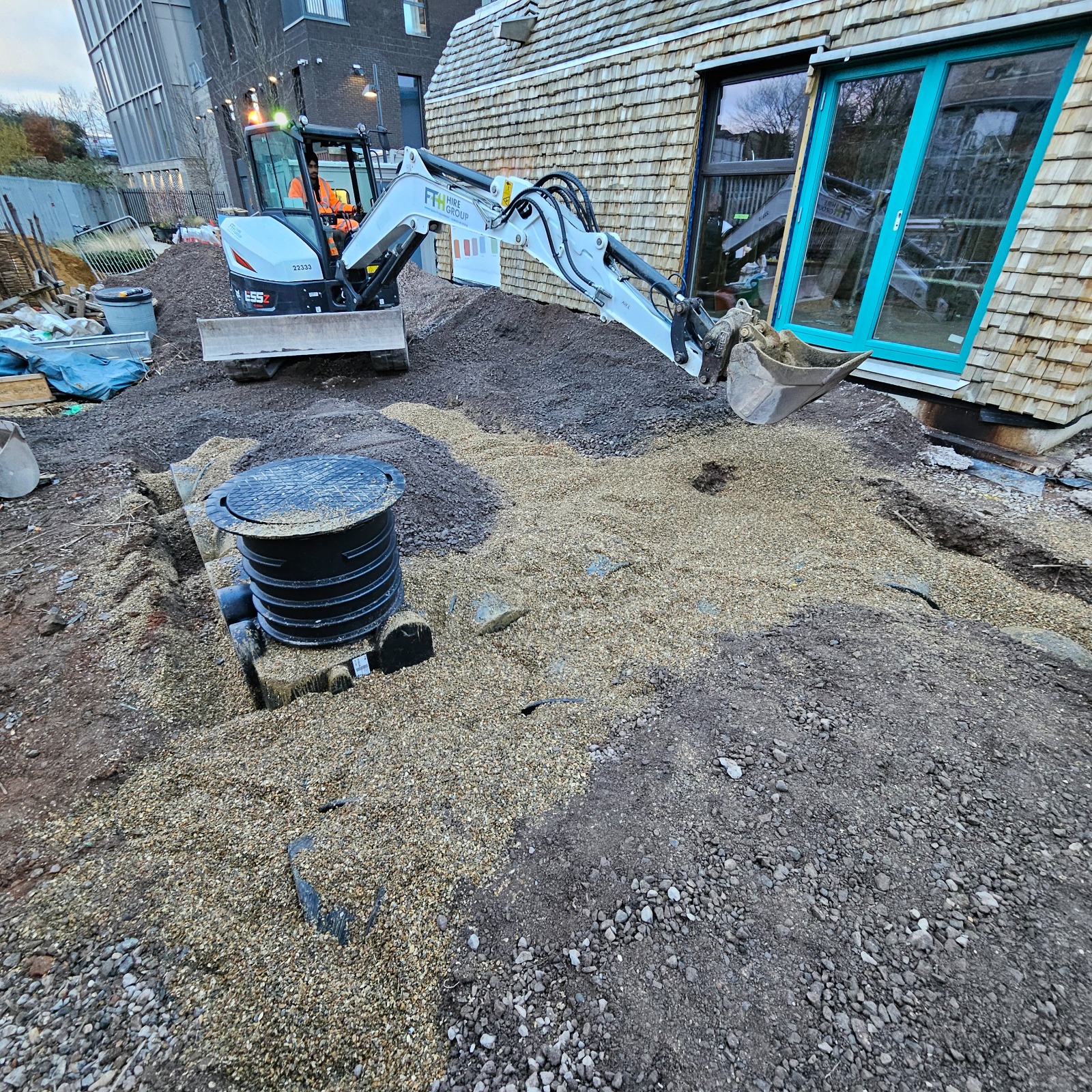 Drainage chamber with an excavator working on site