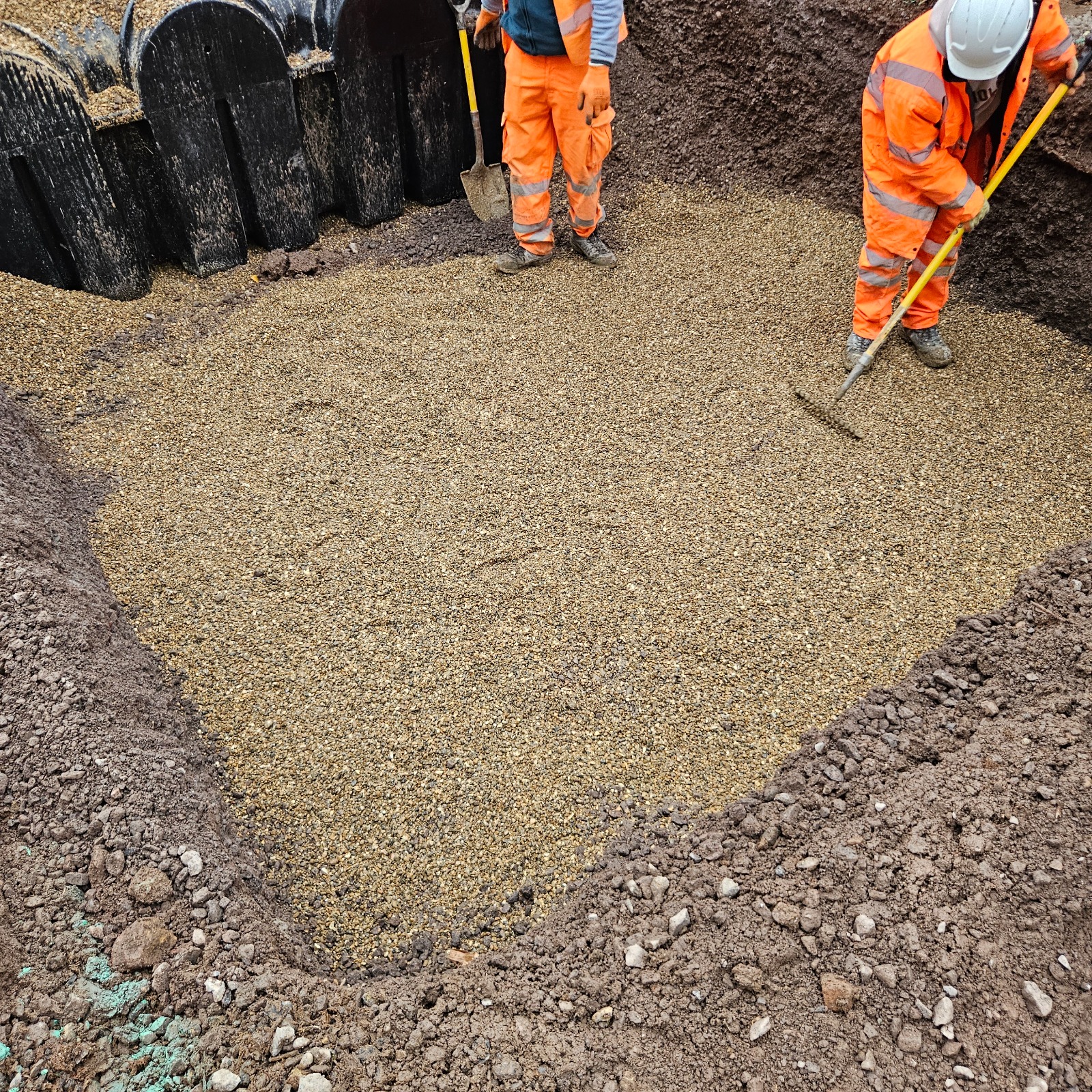Preparing the hardcore base in a rainwater harvesting tank excavation